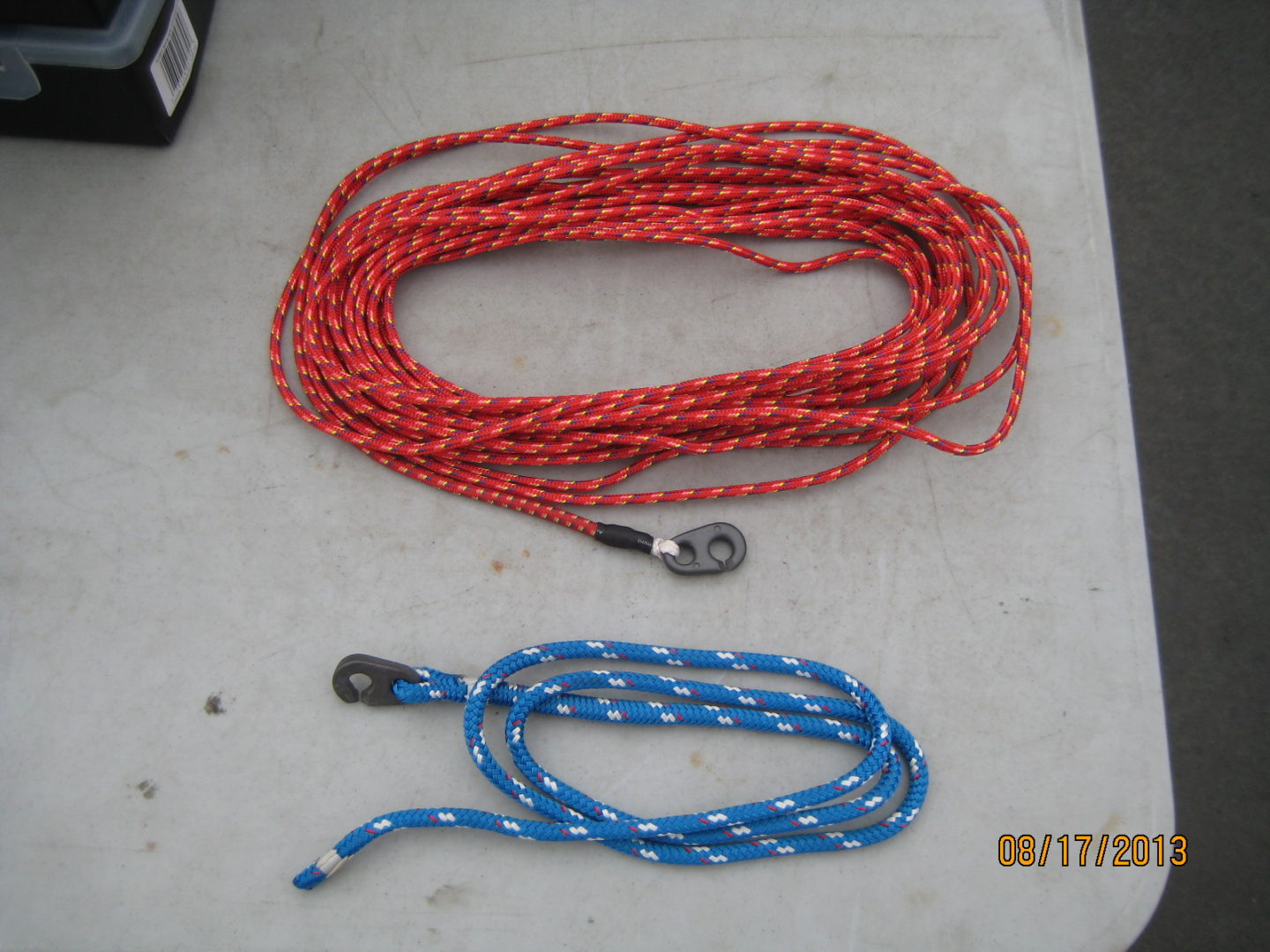 A red rope and blue rope are on the ground.