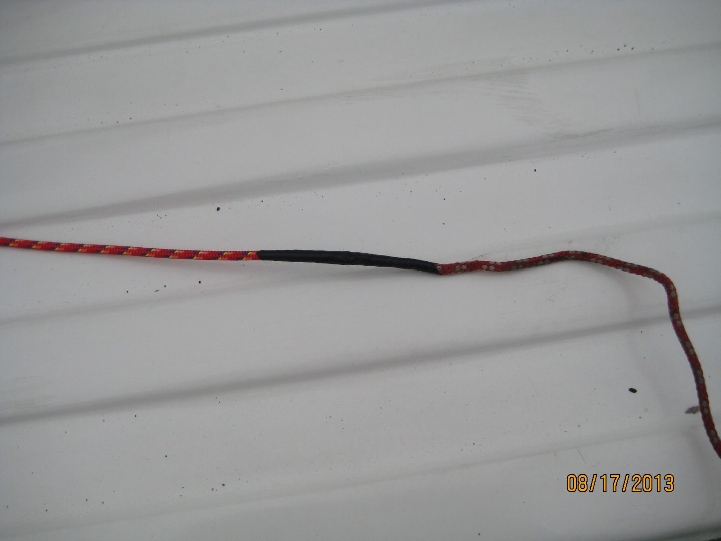 A red and black wire is connected to the wires.