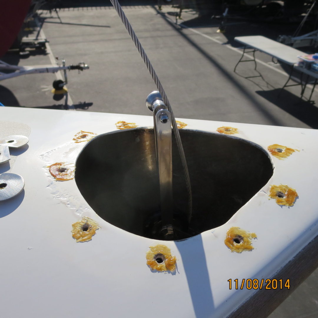 A sink with a hole in it and some flowers on the table