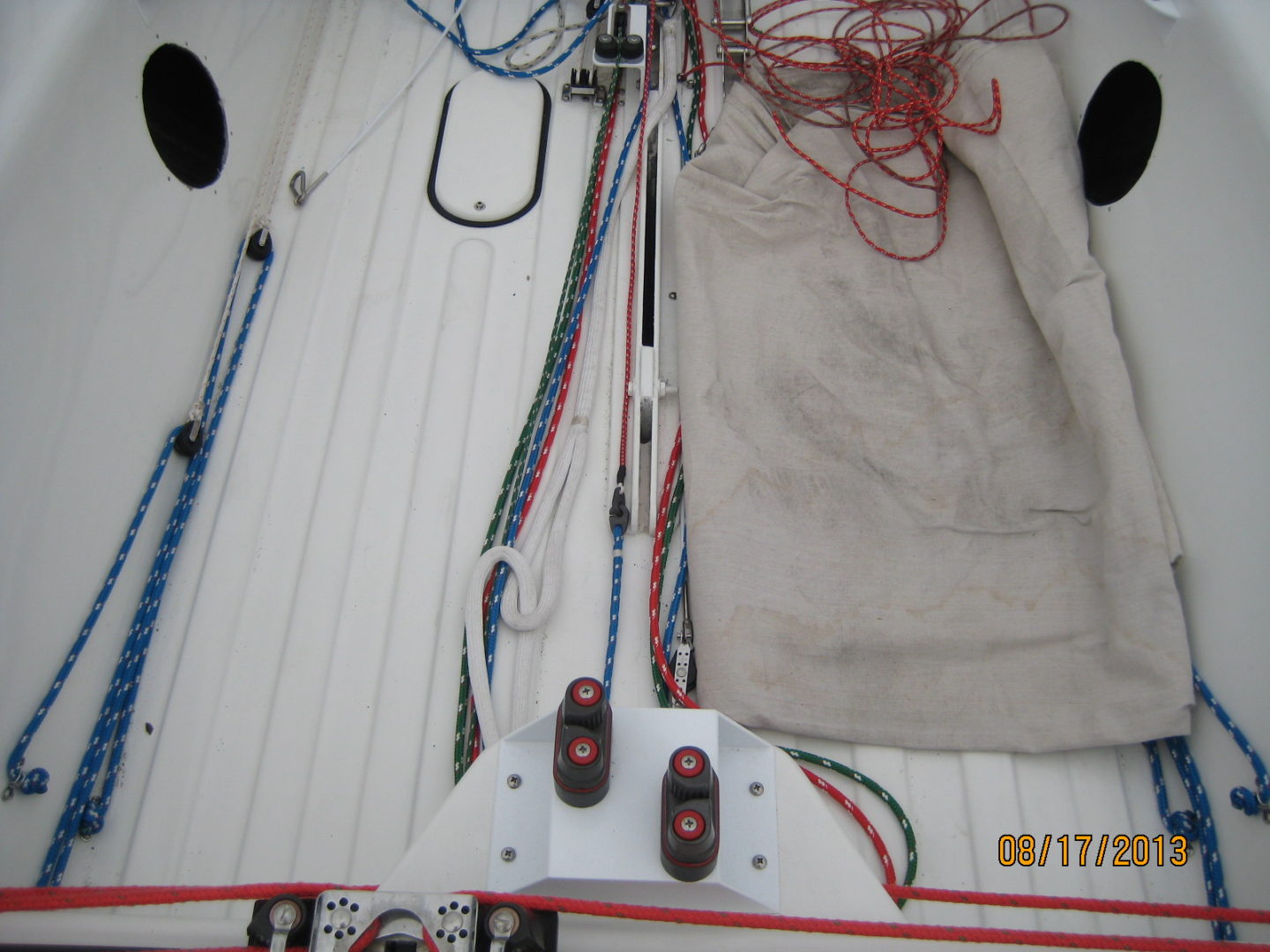 A boat with many ropes and wires on the deck.