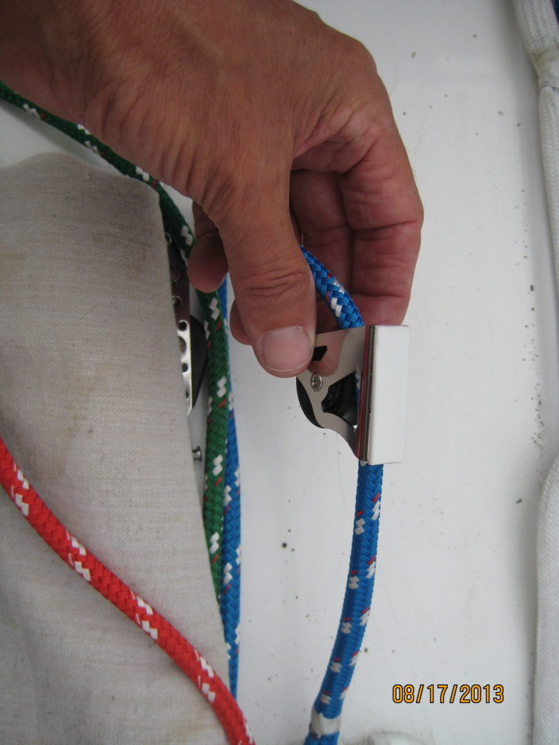 A person holding onto some ropes with a pair of scissors.