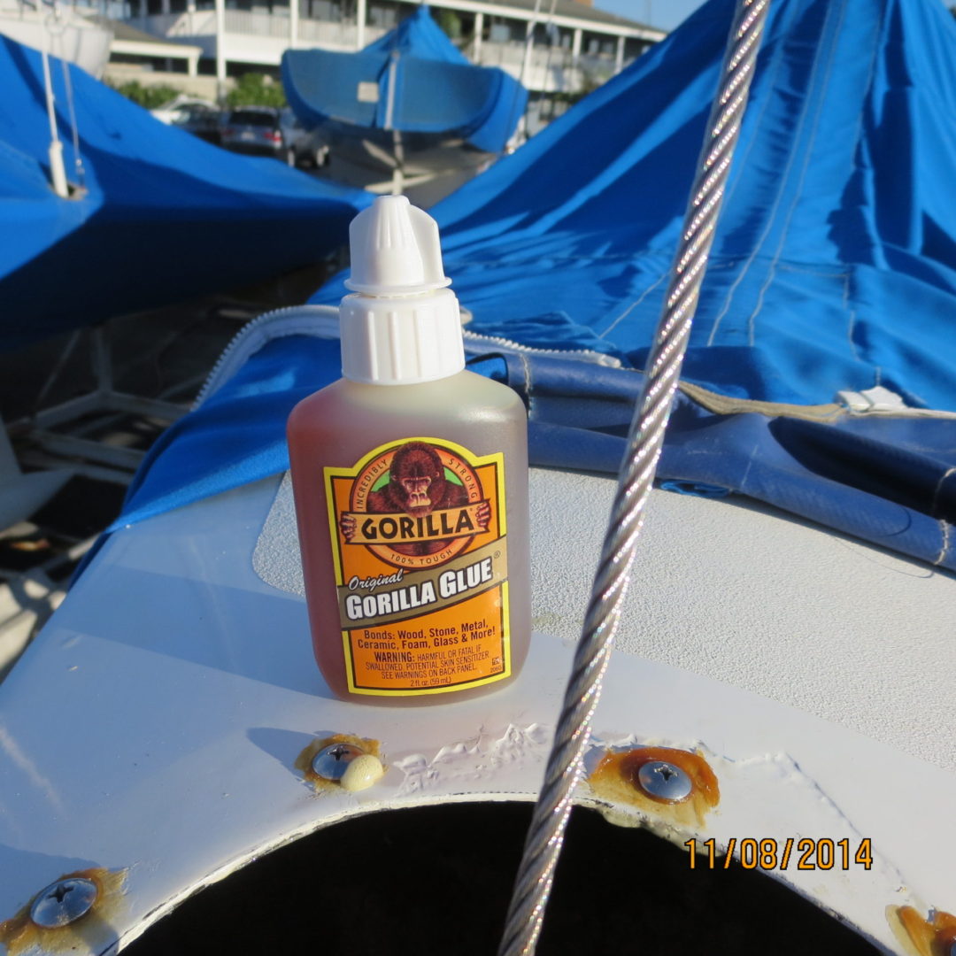 A bottle of glue sitting on top of a boat.