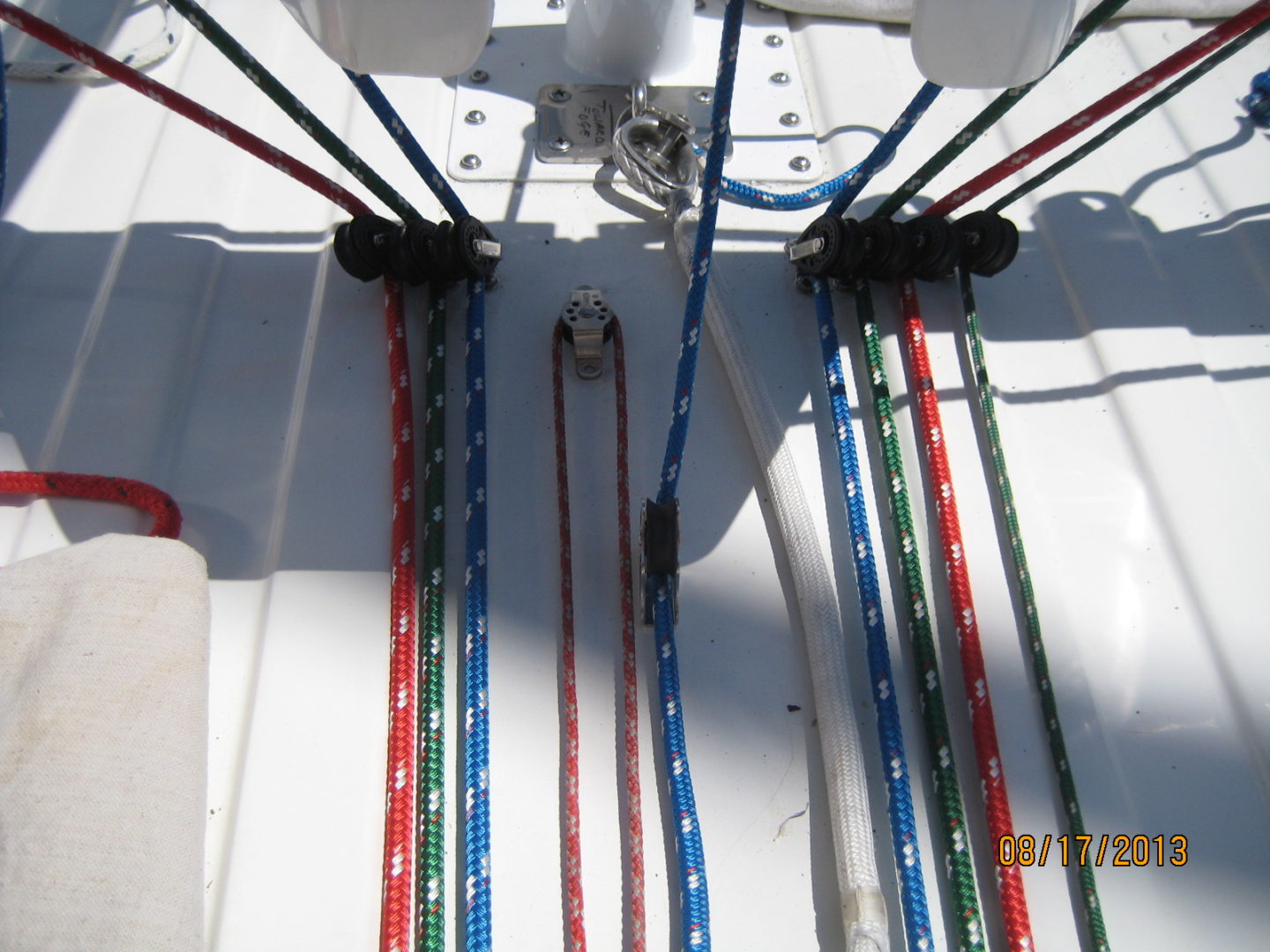 A bunch of ropes are hanging on the side of a boat.