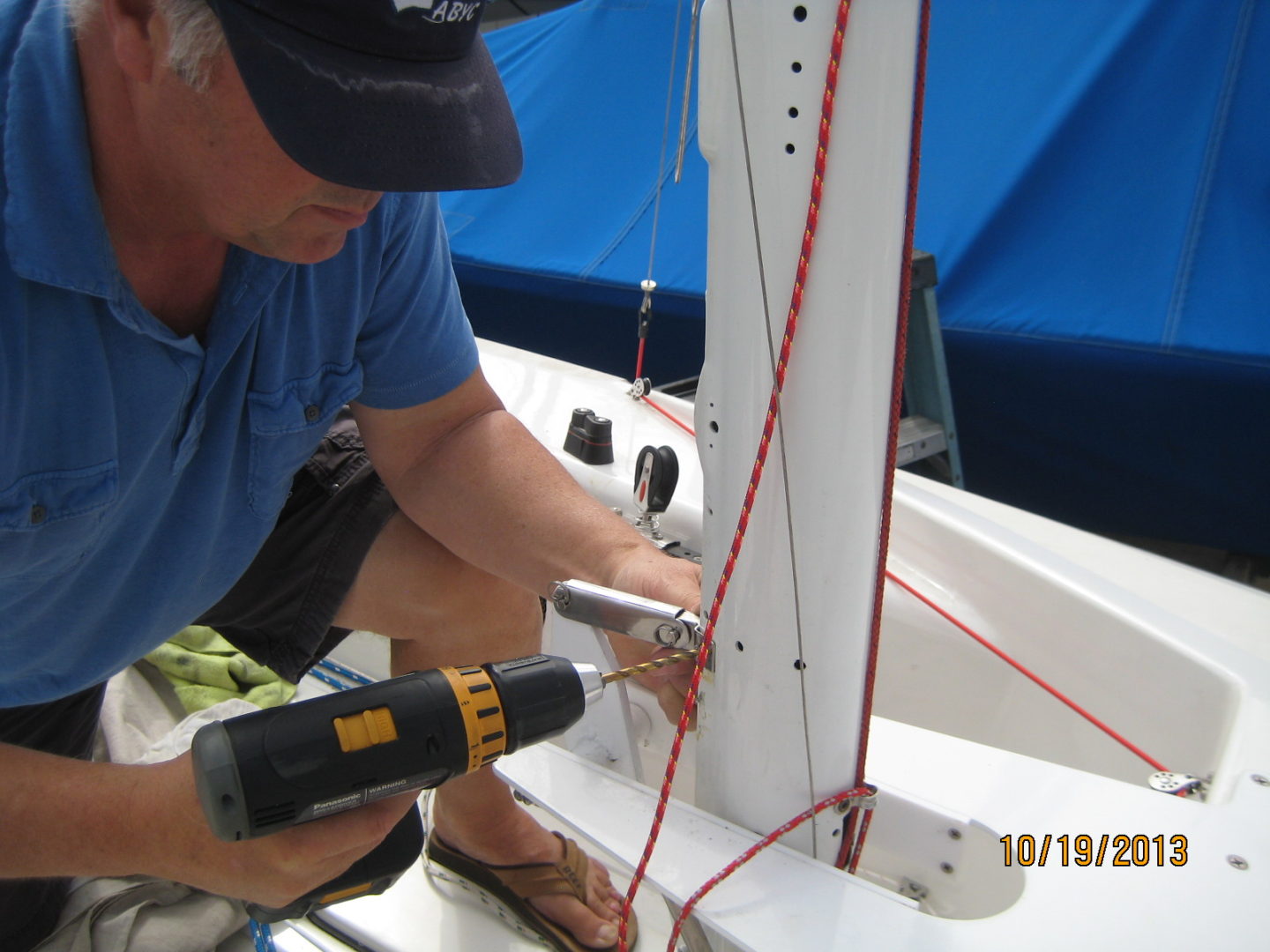 A man working on the side of a boat.