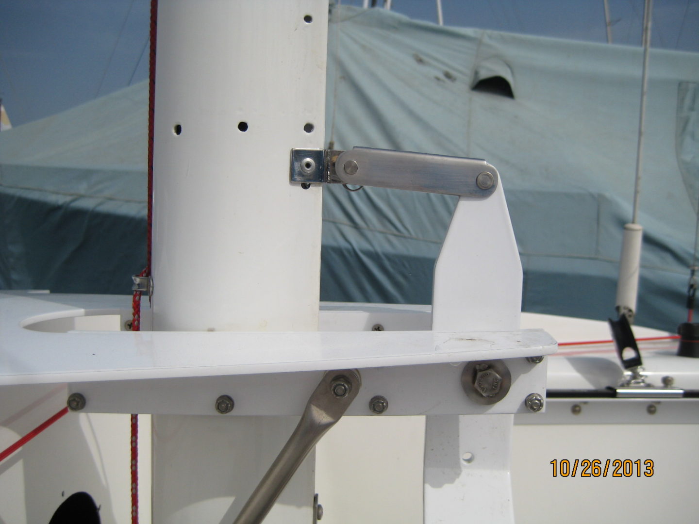 A white boat with a metal pole on top of it.