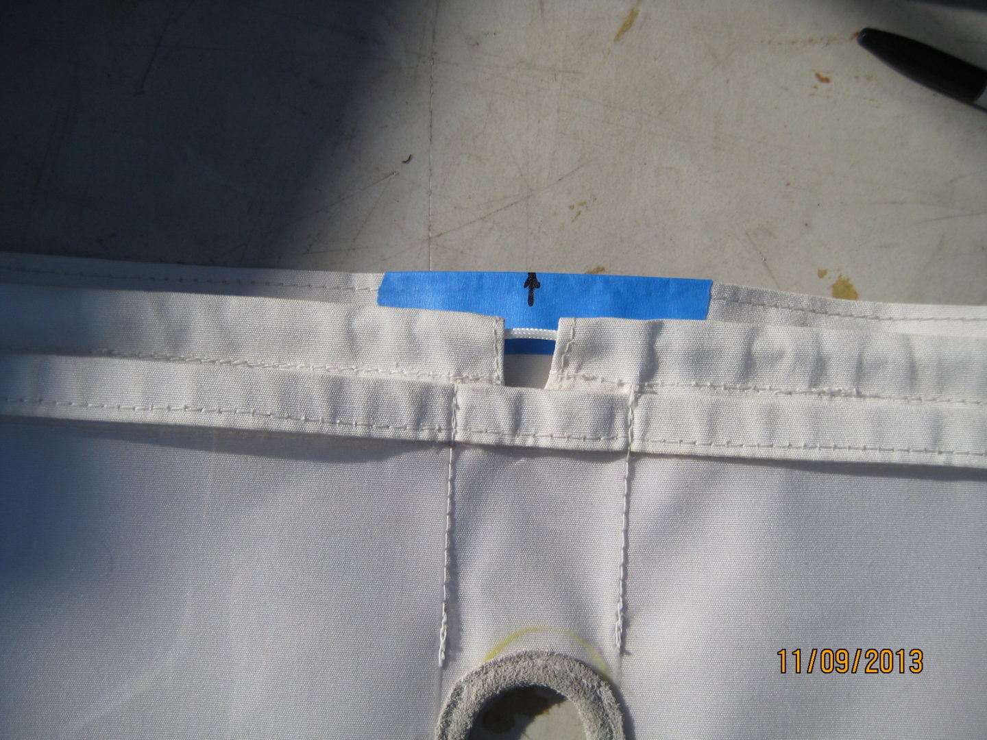 A piece of cloth with blue tape on it.