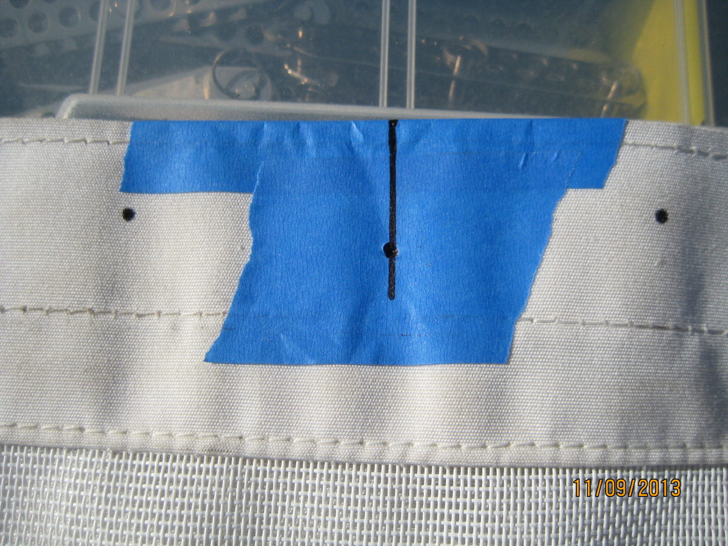 A blue piece of paper taped to the side of an airplane.