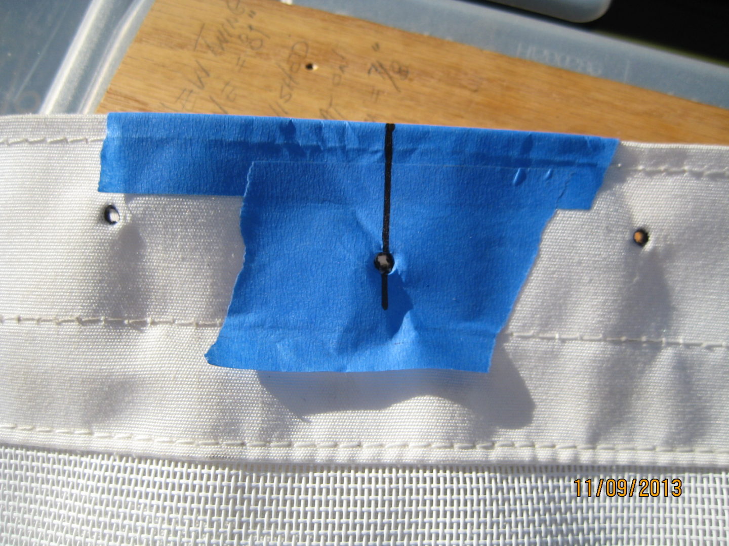 A piece of blue fabric is hanging on the side of a bag.