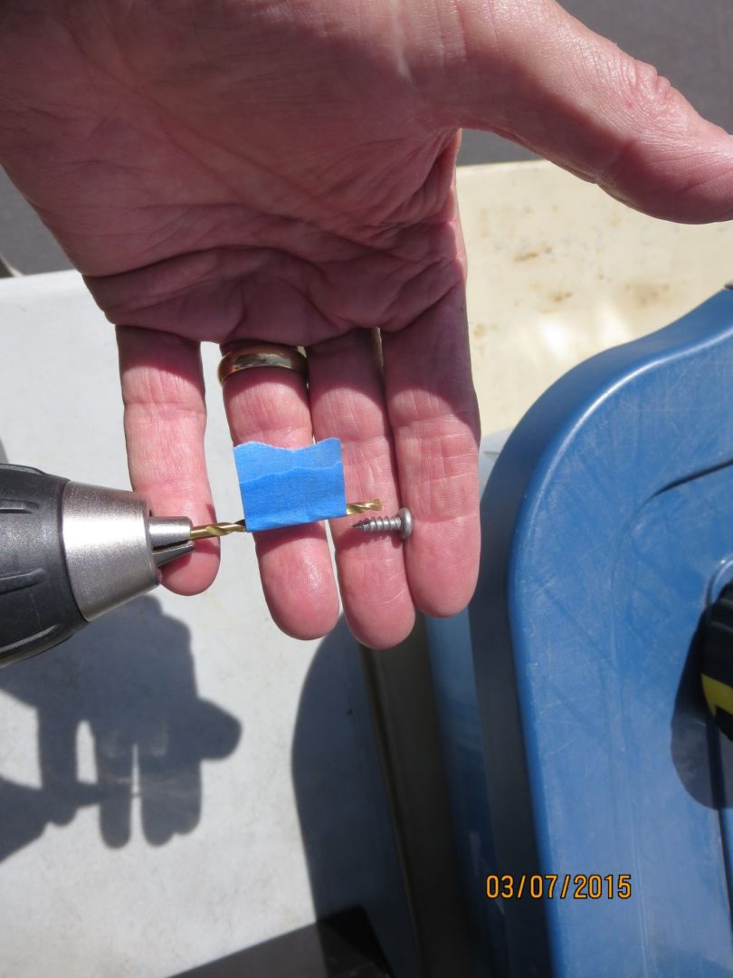 A person holding a blue object in their hand.