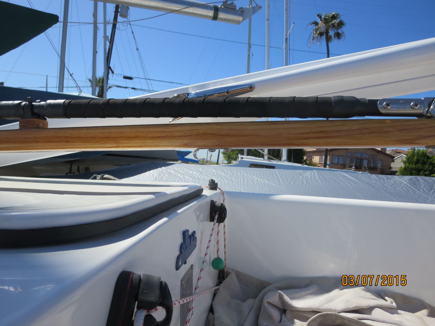 A boat is parked in the water and has two paddles hanging from it.