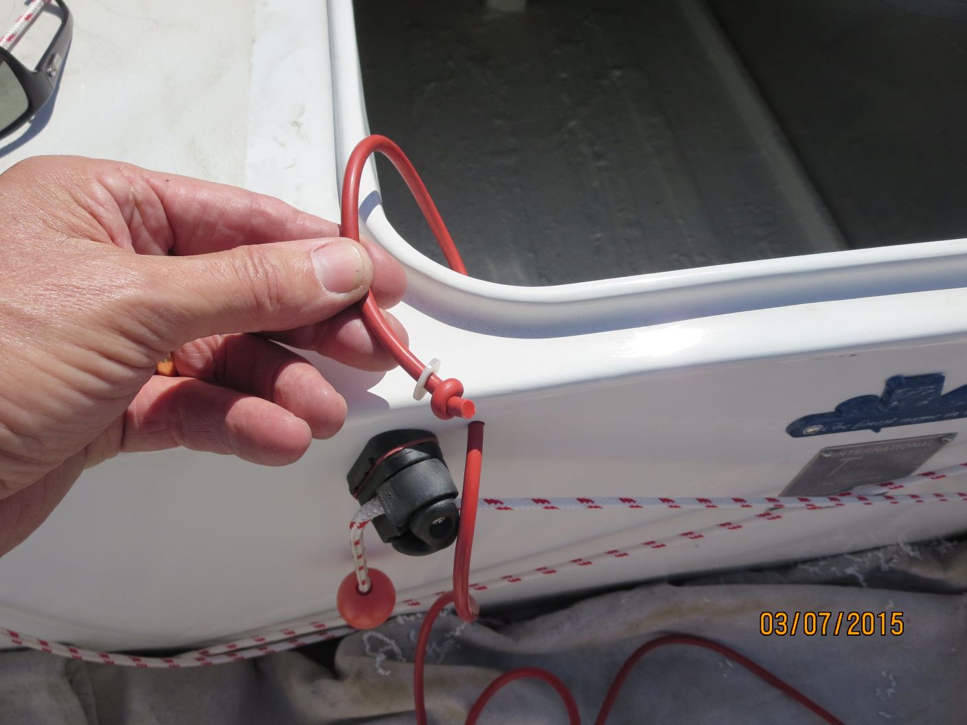 A person holding onto the cord of a boat