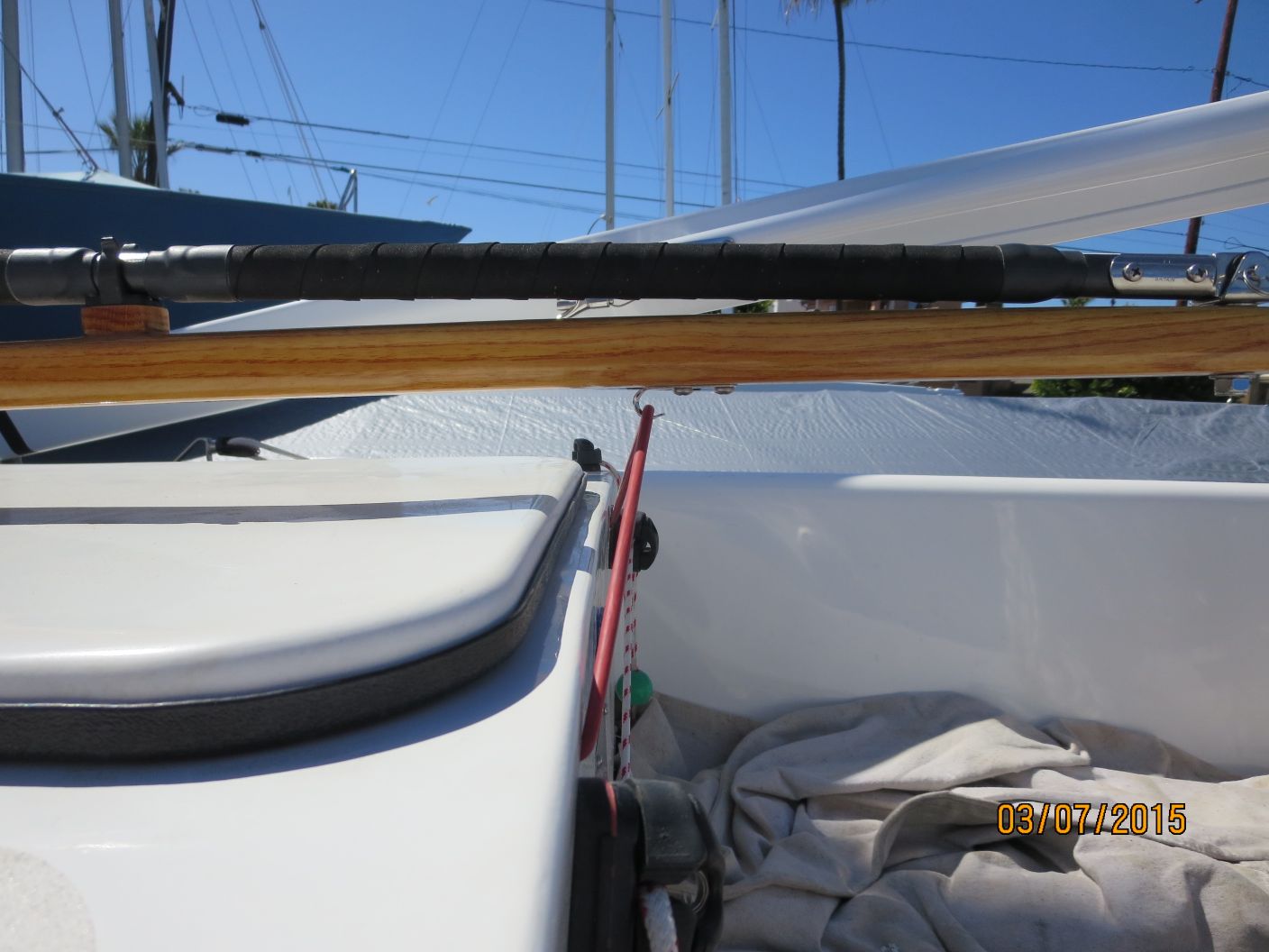 A boat is parked on the dock and has two poles attached to it.