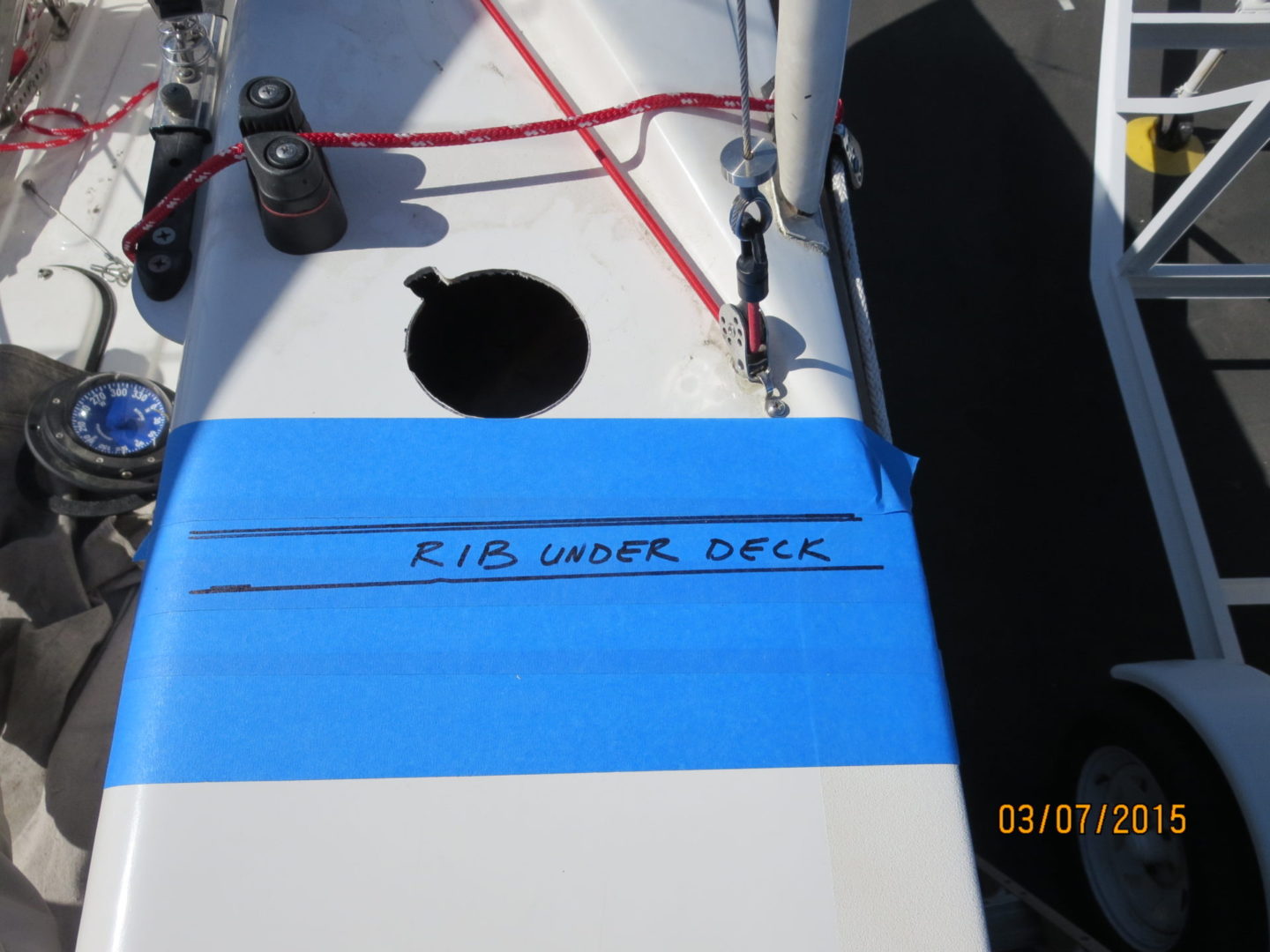 A blue and white boat with a hole in the side of it.