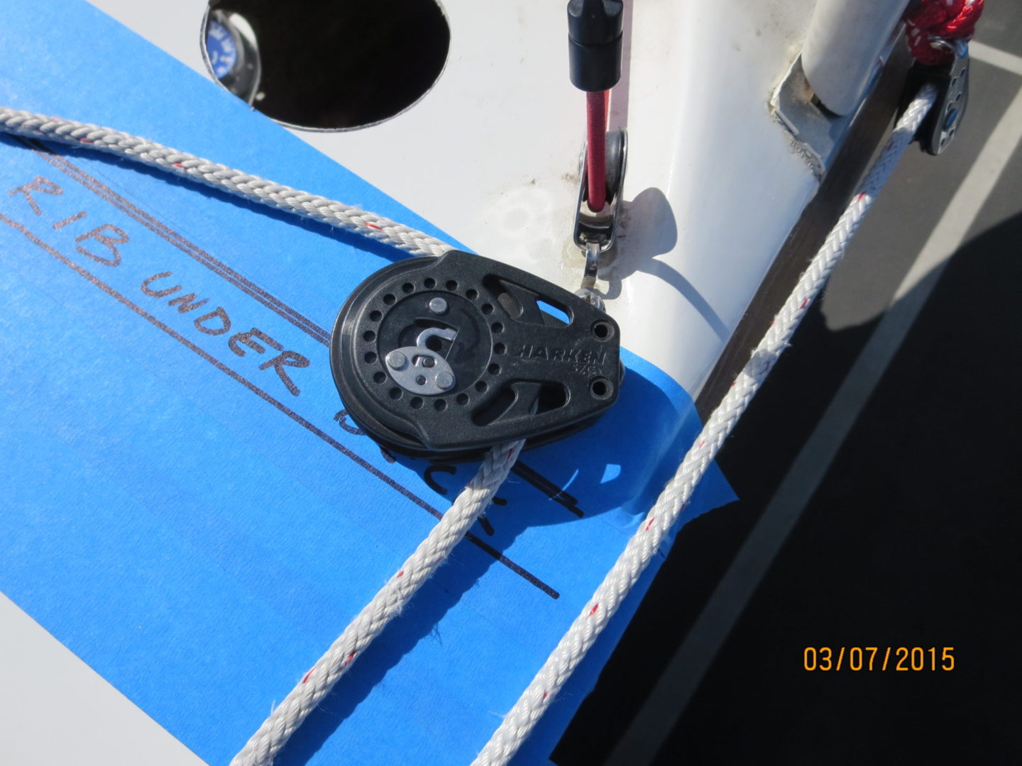 A close up of the side of a boat with ropes