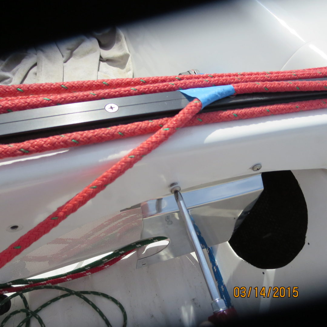 A red rope is tied to the side of a boat.