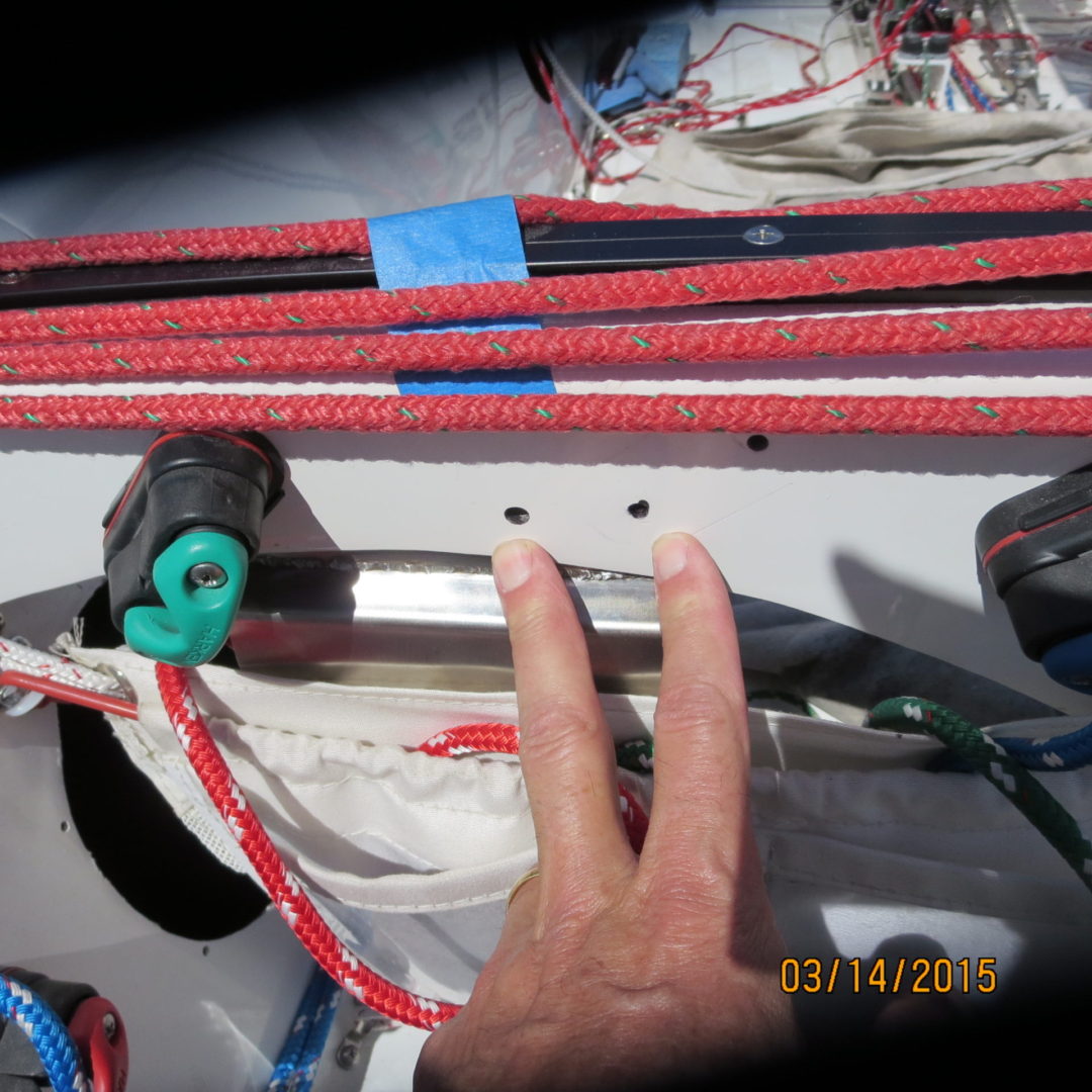 A person touching the bottom of a boat.