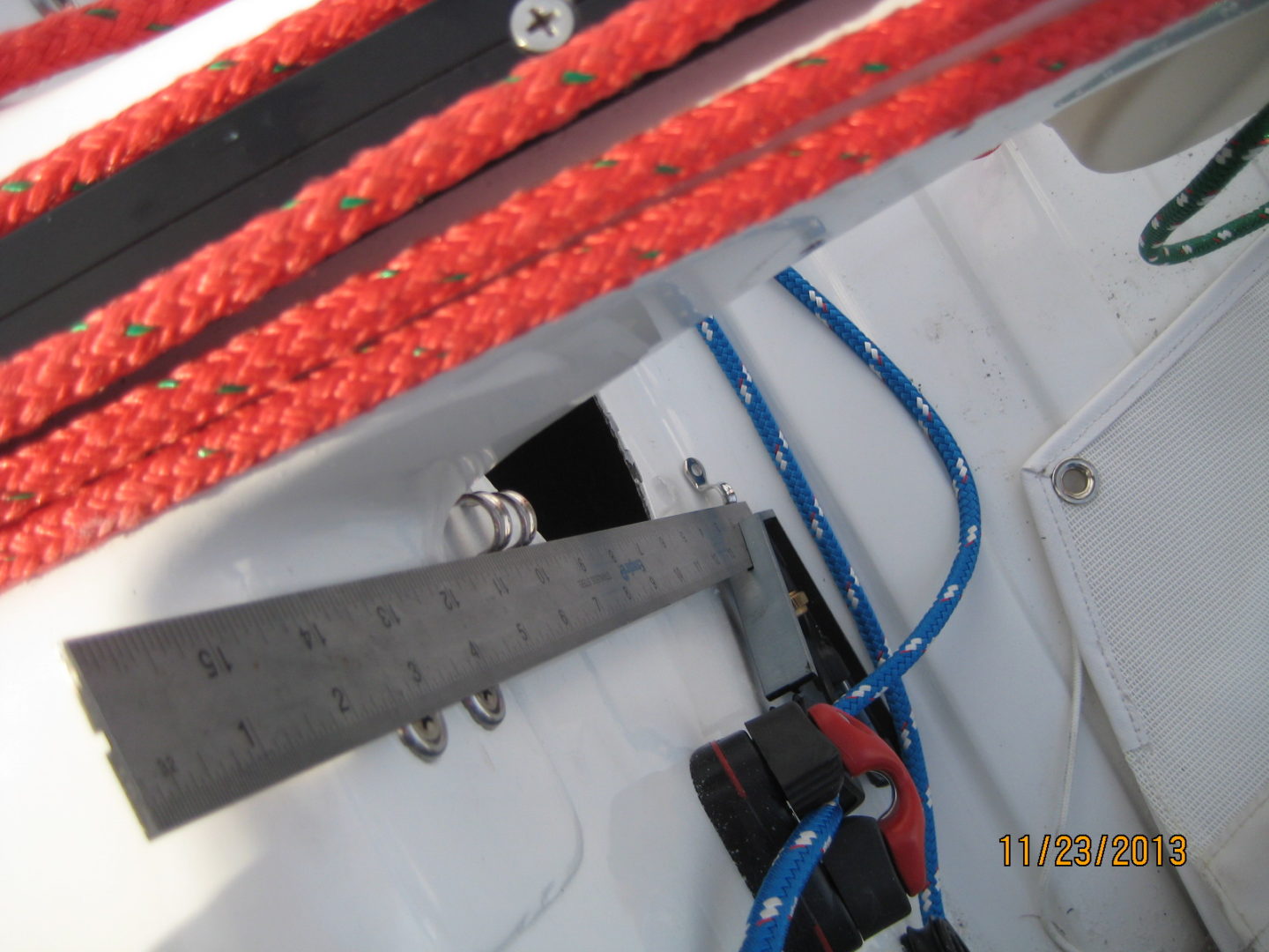 A red rope is tied to the side of a boat.