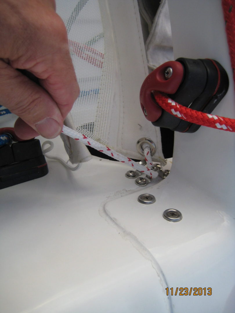 A person using a pair of scissors to cut the wire.