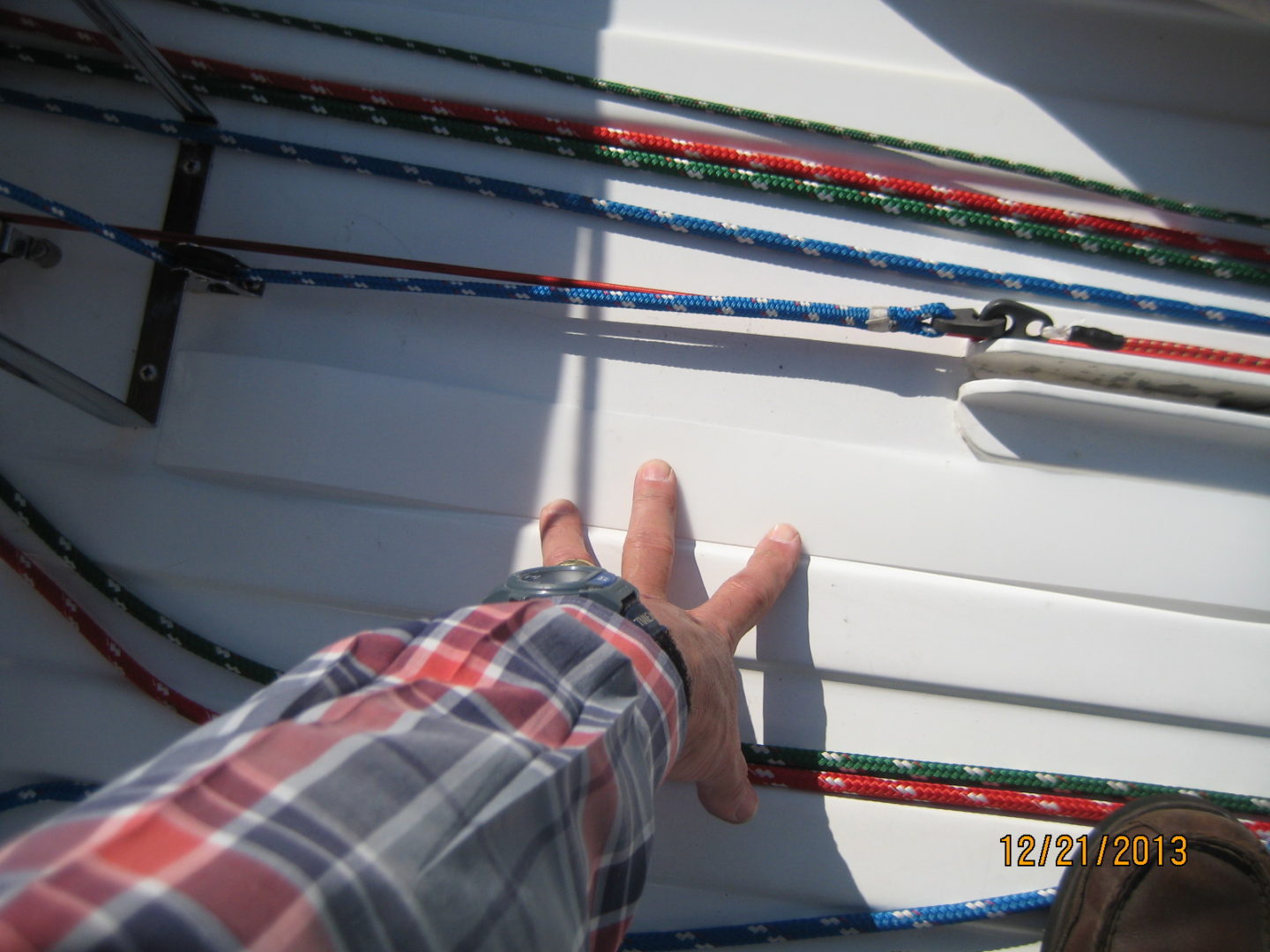 A person 's feet on the deck of a boat.