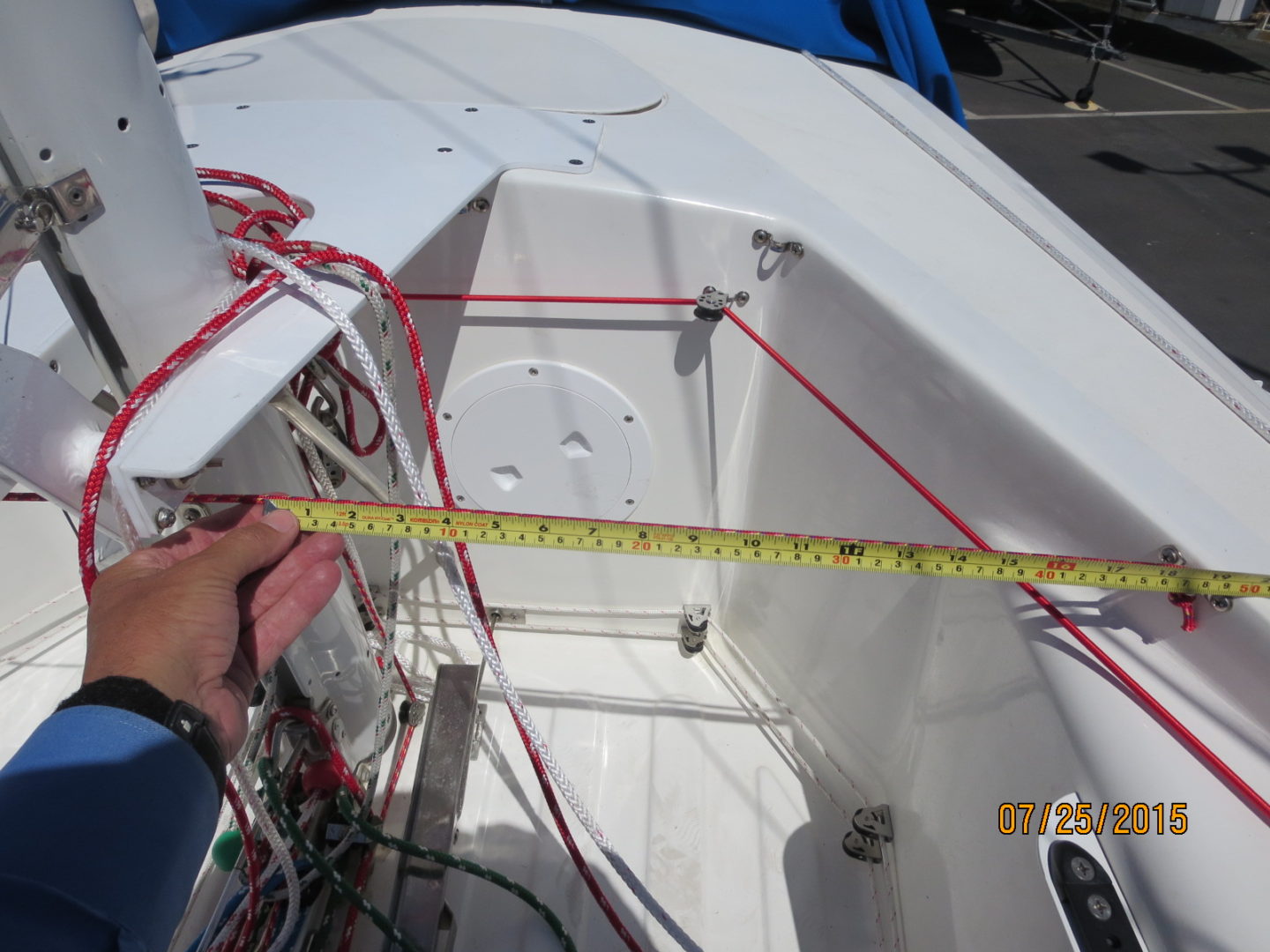 A person is measuring the length of a boat.