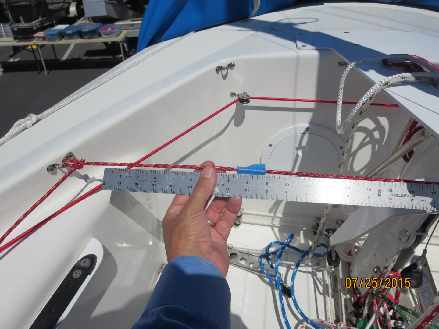 A person measuring the length of a boat.