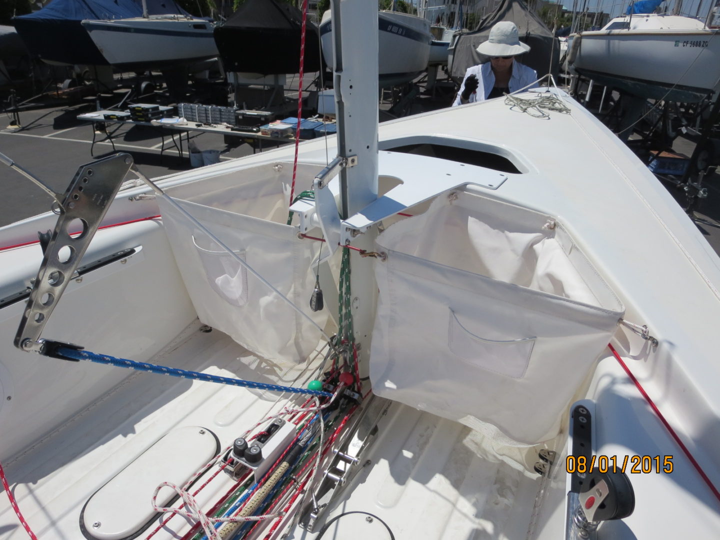 A white sailboat with two sails on the water.