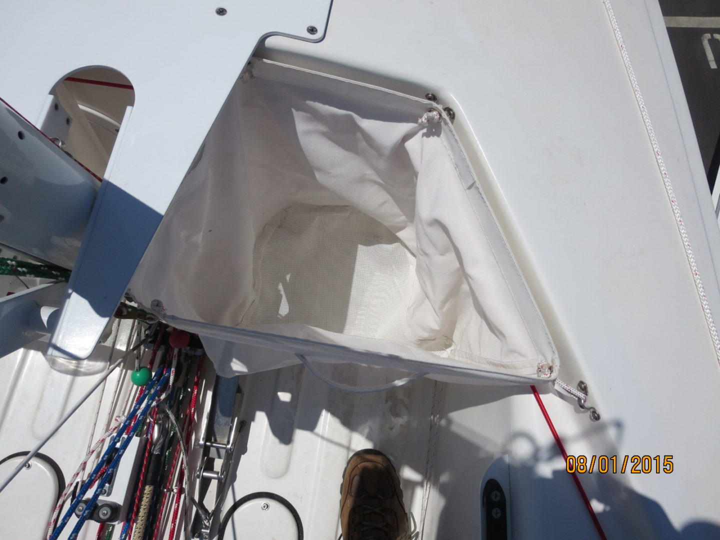 A white boat with some wires hanging from it