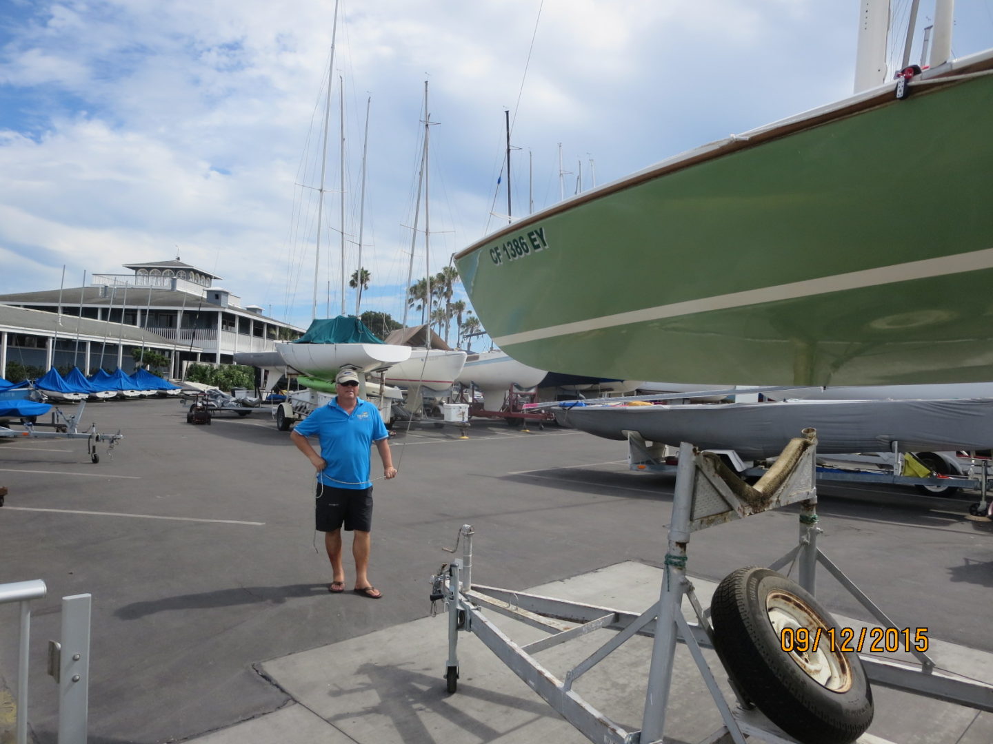 A man standing next to a boat in the water.