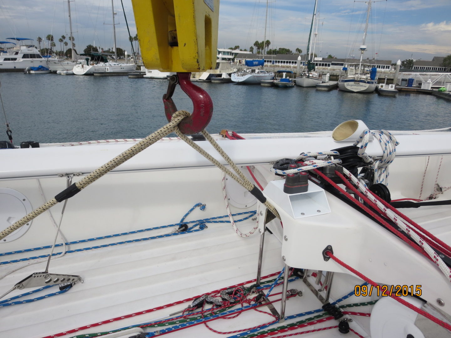 A boat with ropes and a yellow sail on the deck.