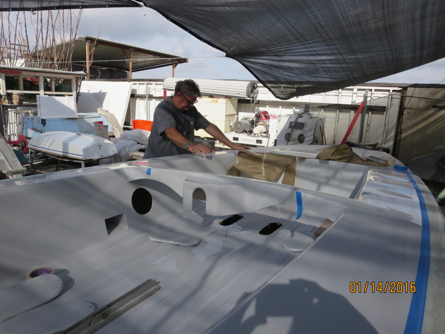 A man working on the wing of an airplane.