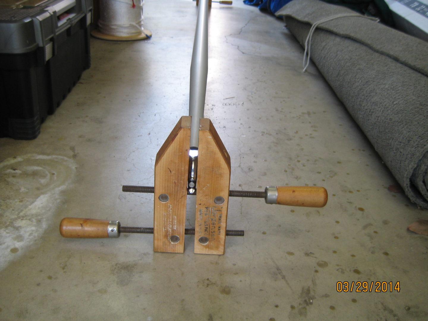 A pair of wood clamps with wooden handles.