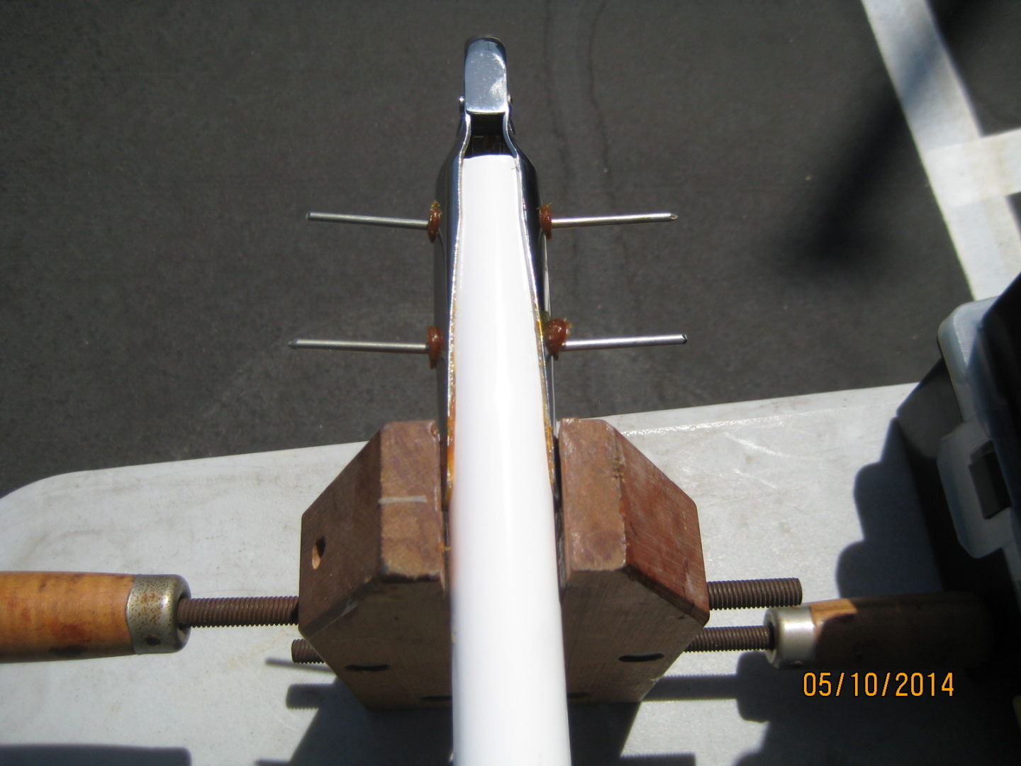 A white pipe sitting on top of a cement floor.