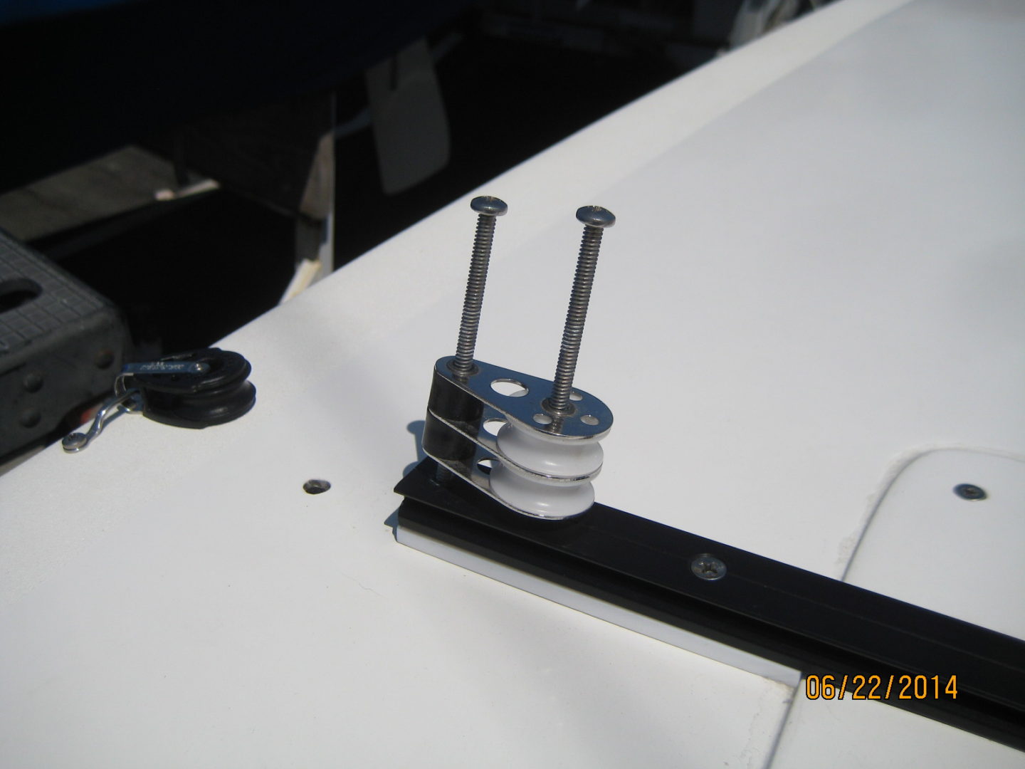 A close up of the side of a boat with two bolts and one piece.