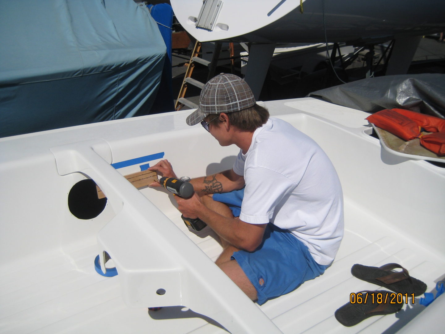 A man working on something in the back of a boat.