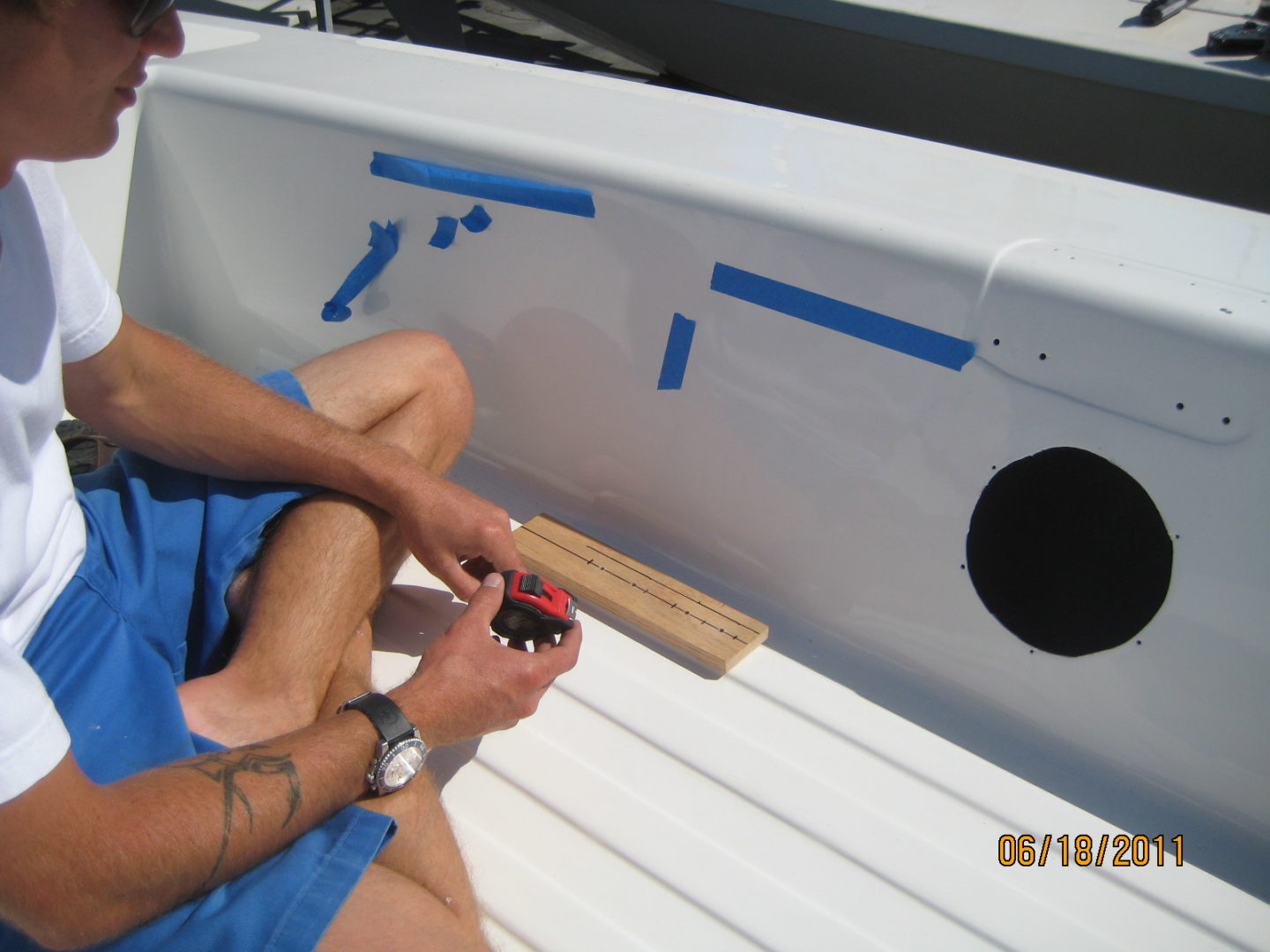 A person sitting on the back of a boat.