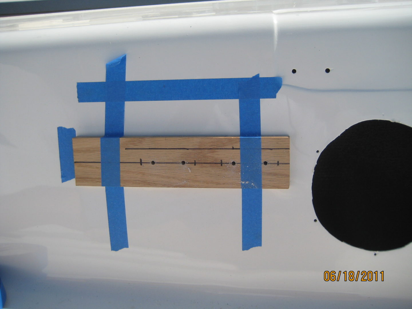 A white plane with blue tape on it.