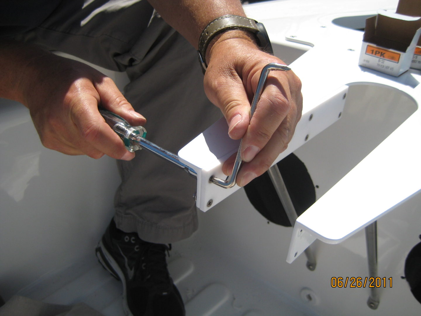 A man is working on the bottom of a boat.