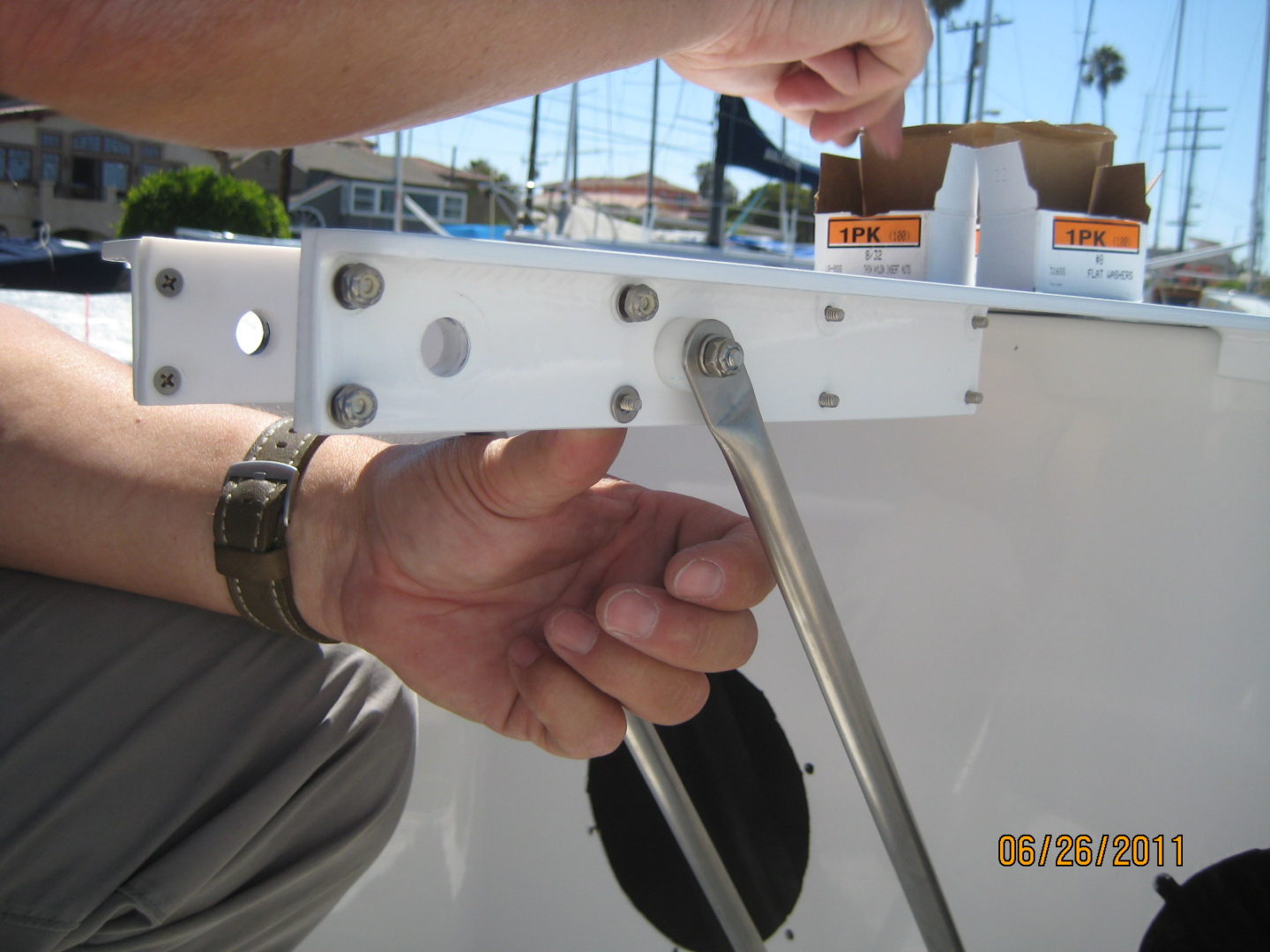 A person holding onto the handle of a boat