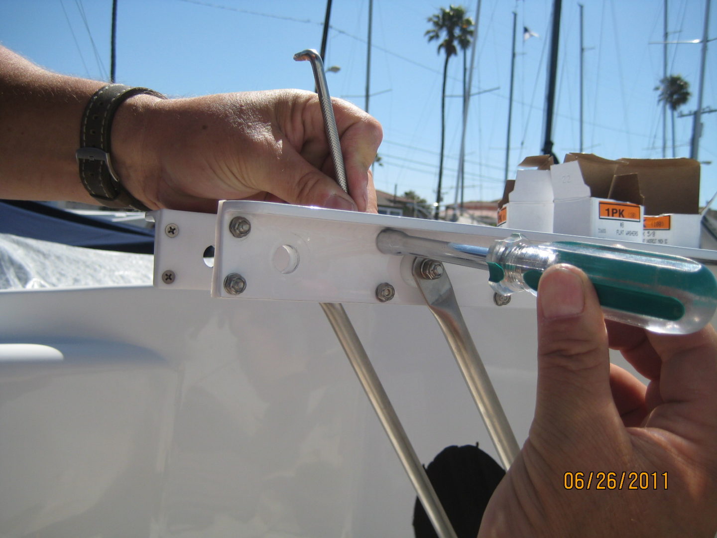 A person is working on the side of a boat.