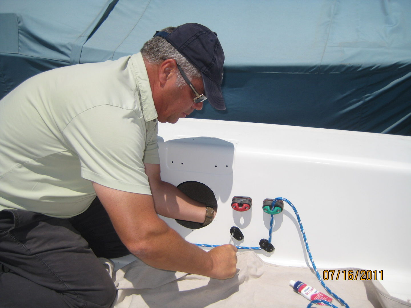 A man working on the side of a boat.