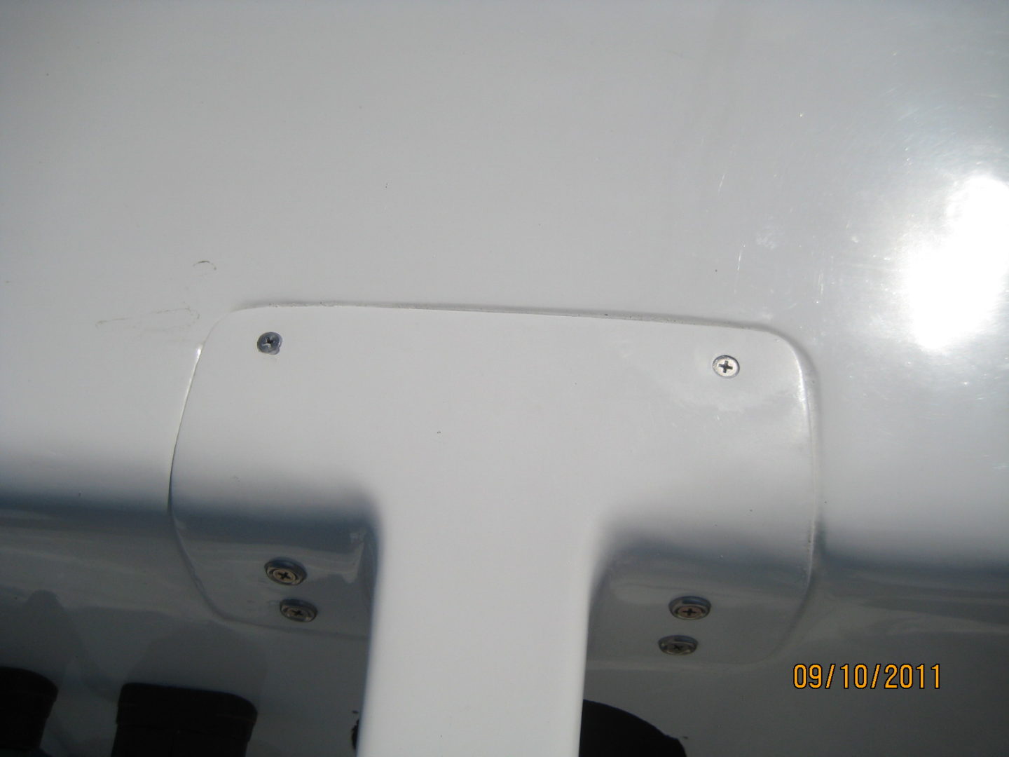 A white airplane with two holes in the side.