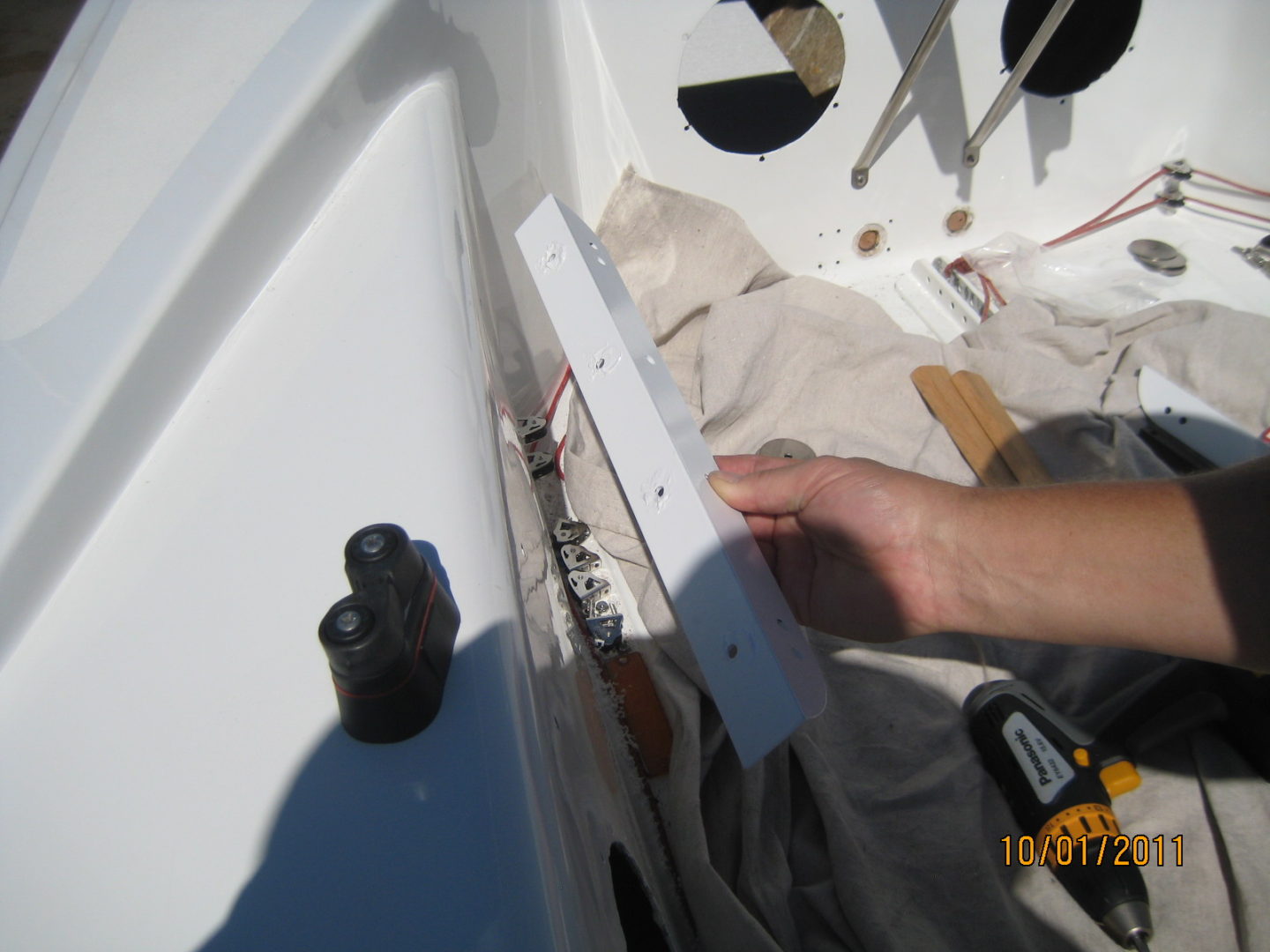 A person is working on the side of a boat.