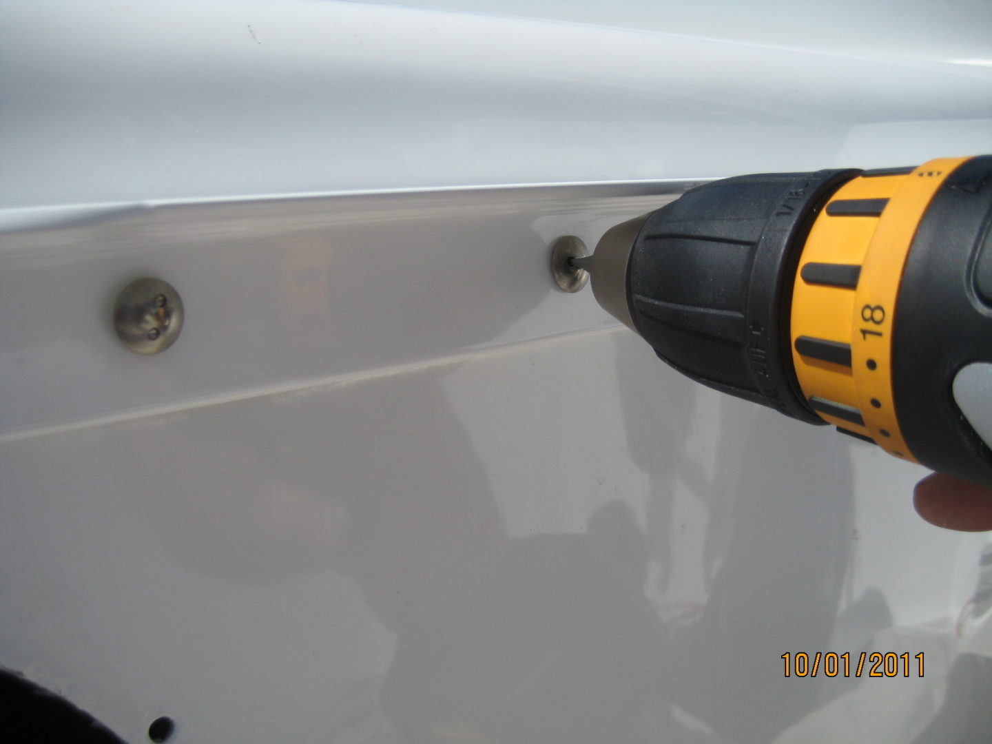 A close up of a drill on the side of a vehicle.