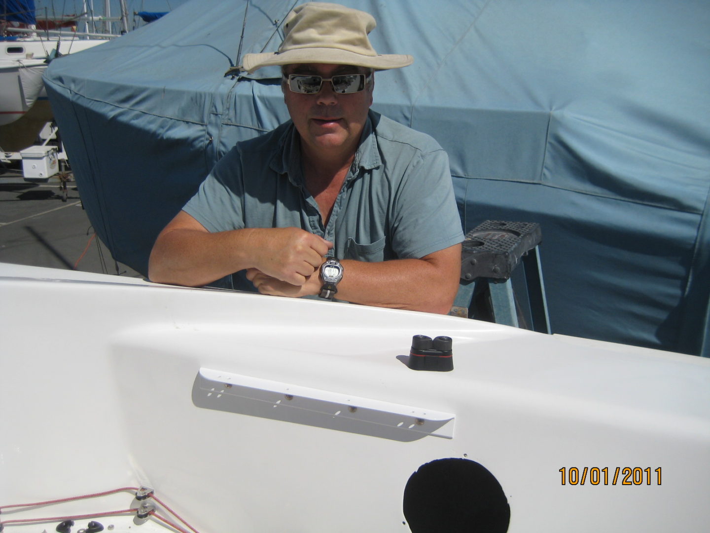 A man sitting on top of a boat in the water.