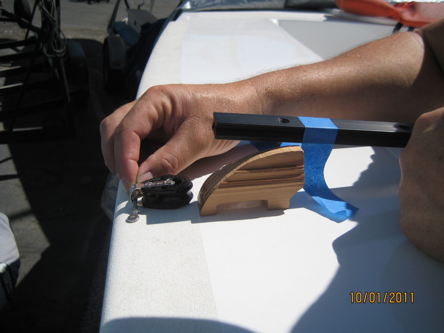 A person using a small tool to cut wood.