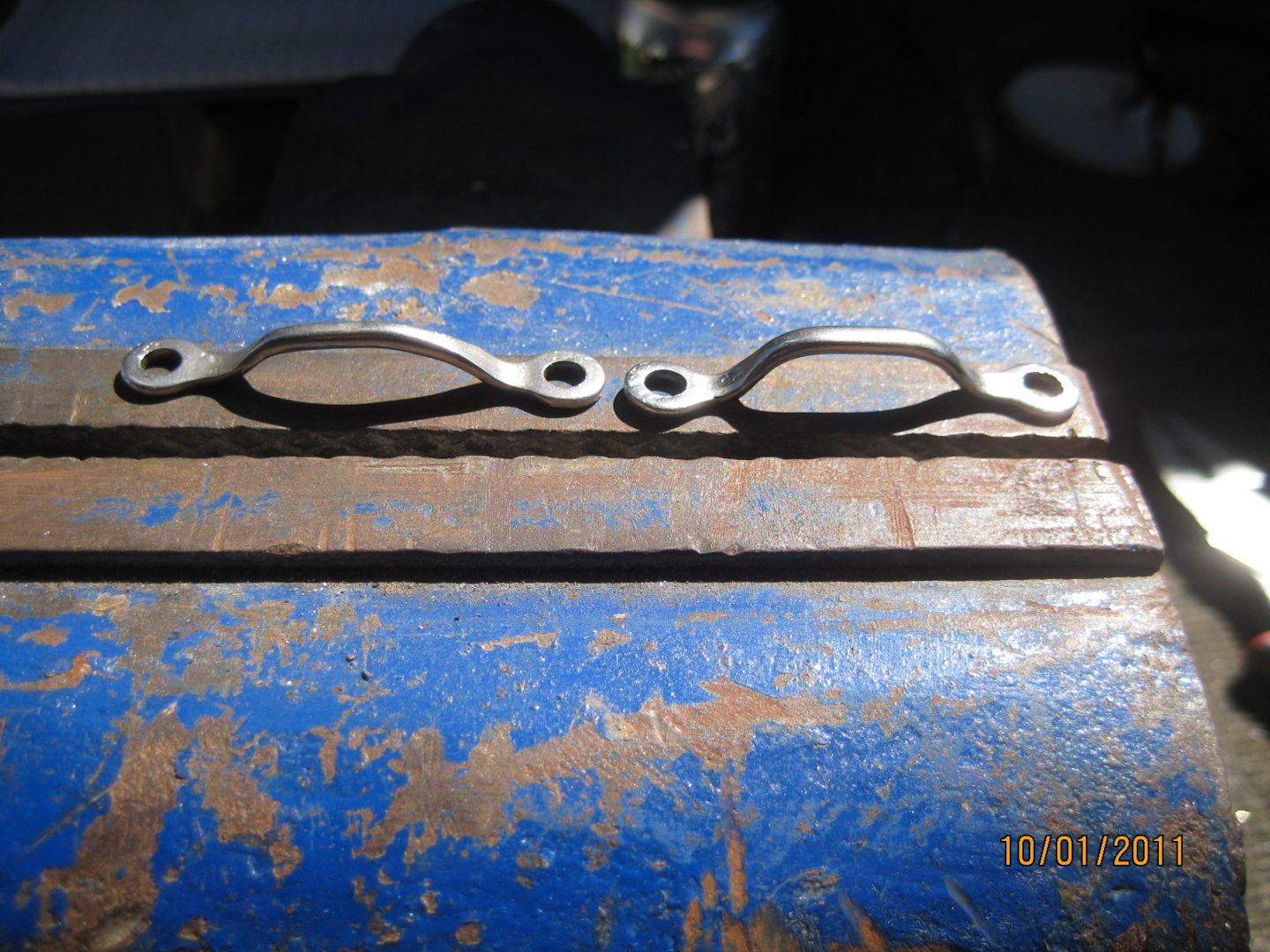 A close up of the exhaust manifold on an old car.