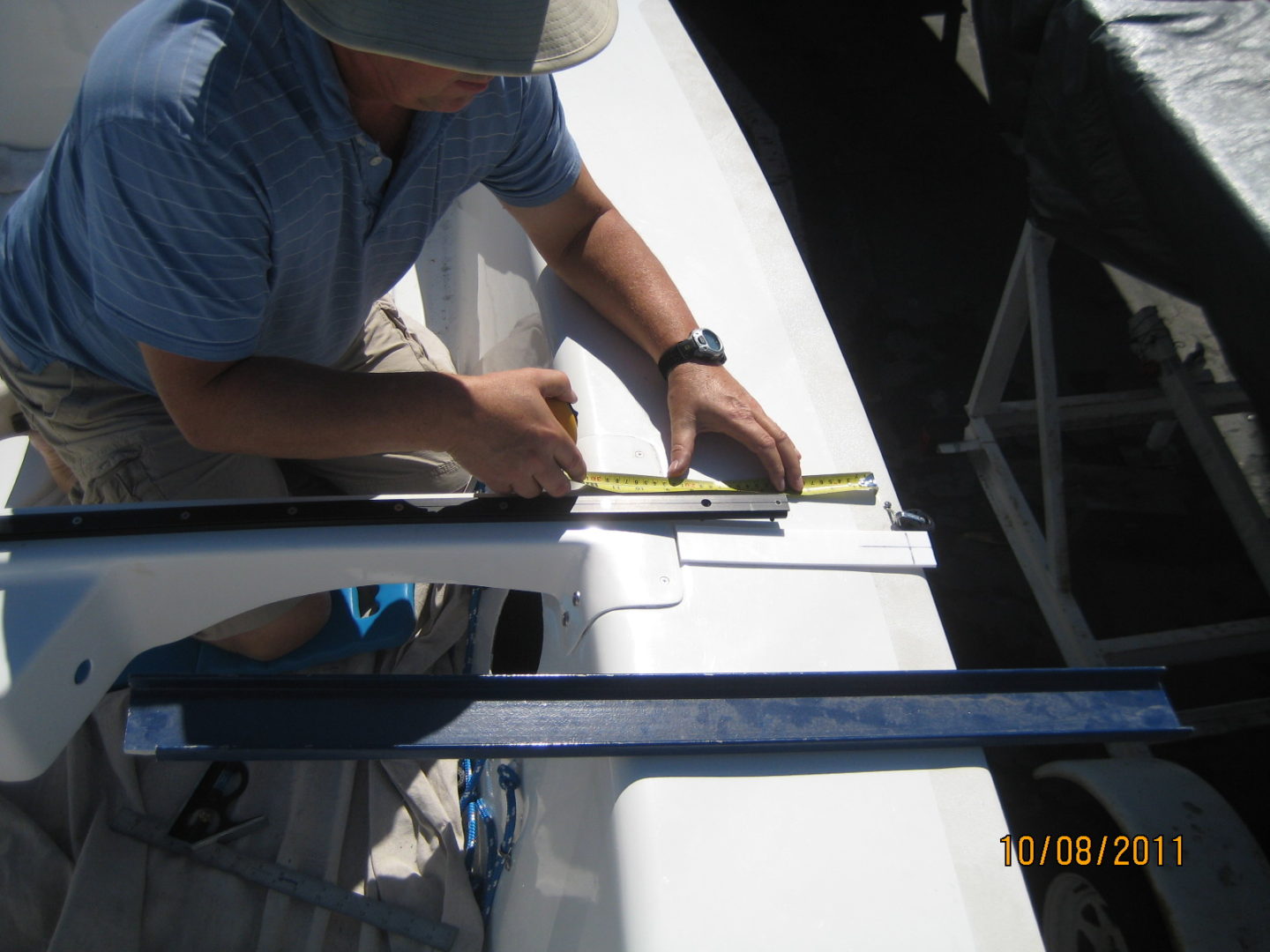 A man measuring the length of a boat.