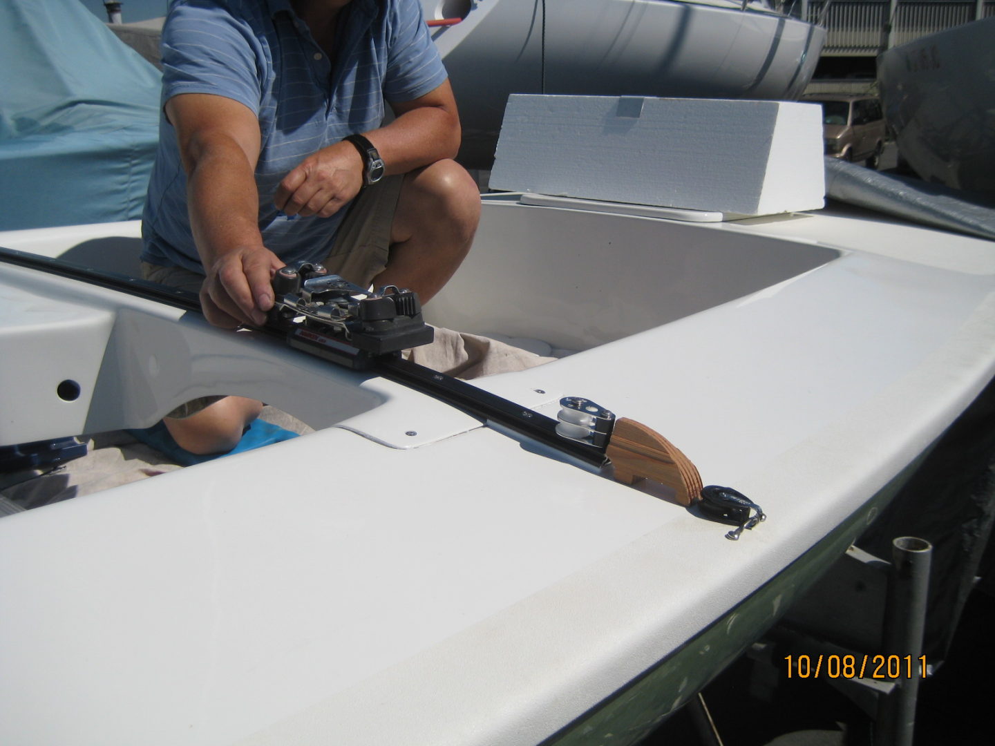 A man working on the front of a boat.