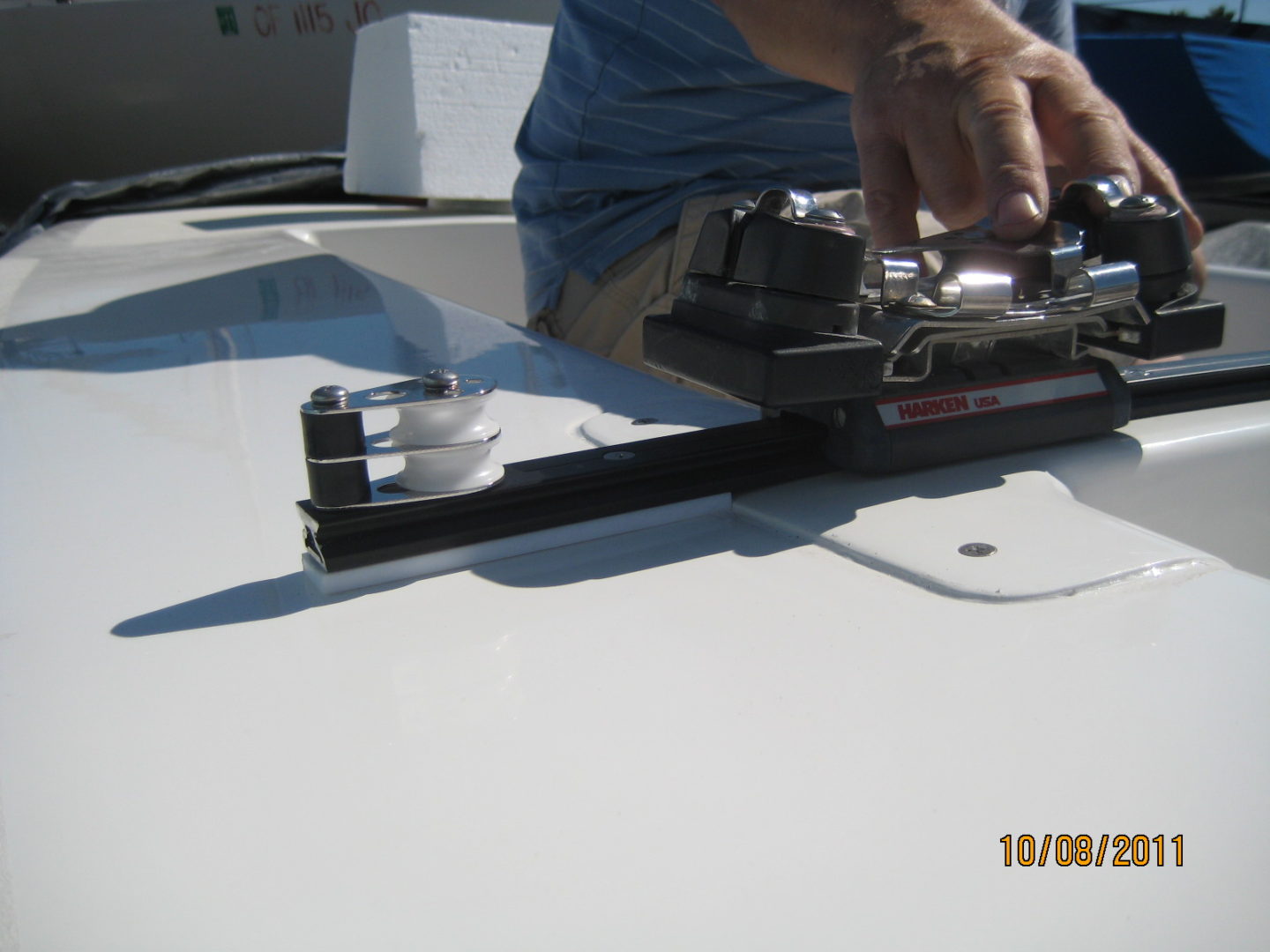 A person is working on the top of a boat.