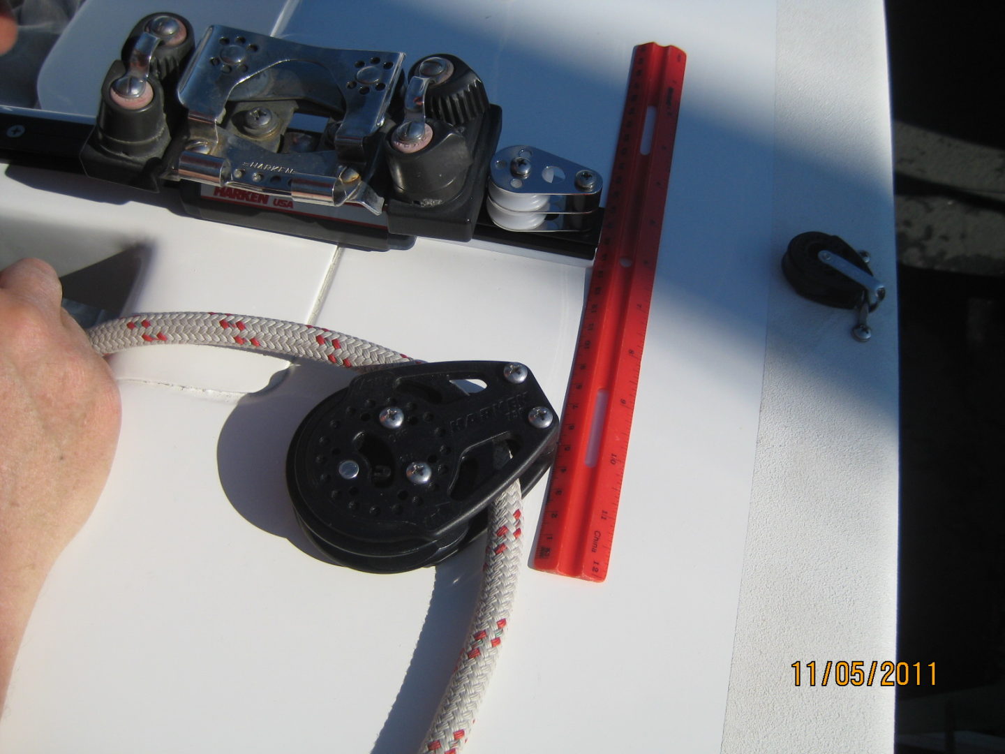 A red rope is tied to the side of a boat.